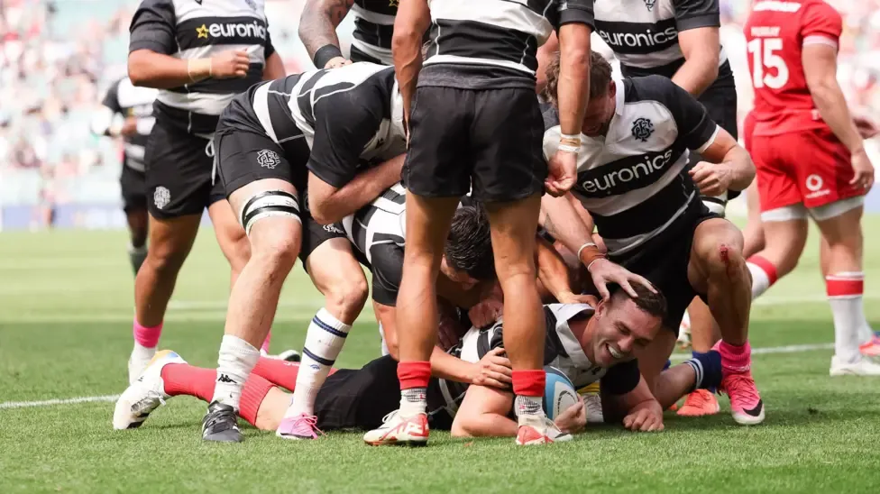 George North is congratulated by Barbarians teammates