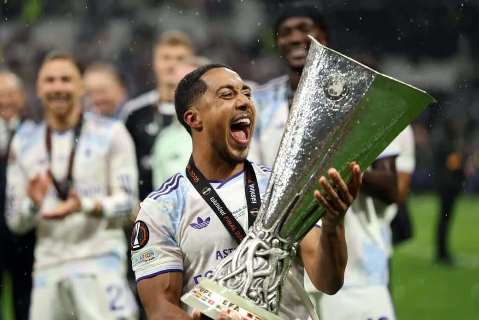 Youri Tielemans of Aston Villa celebrates while holding the UEFA Europa League trophy.