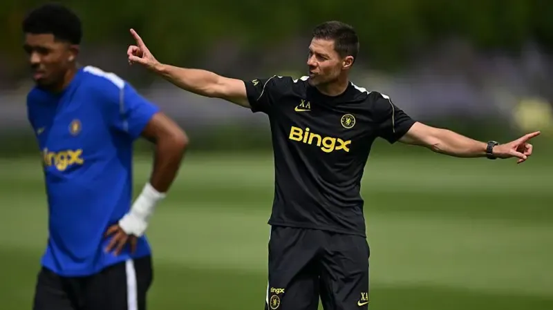 Xabi Alonso pointing with both fingers outstretched in training and Chelsea defender Wesley Fofana is in the foreground