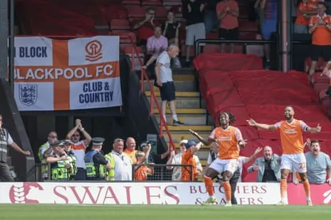 Niall Ennis celebrates after giving Blackpool an early lead against Grimsby Town.