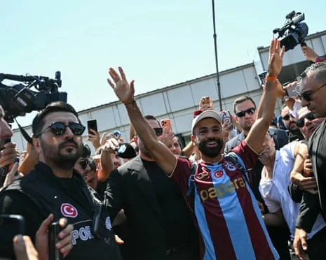 Mohamed Salah gestures as he arrives at Istanbul Ataturk Airport to complete his transfer to Turkish football club Trabzonspor