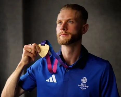Josh Kerr of Scotland poses with his gold medal the morning after his victory in the men's mile.